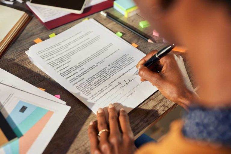 african american woman hand signing buiness contraacts